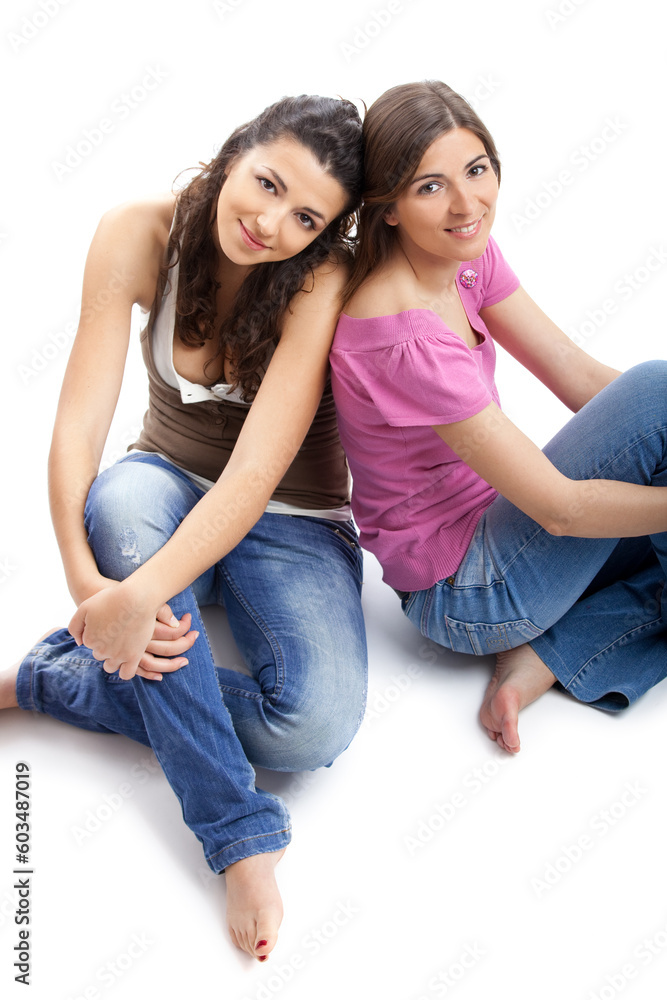 Two beautiful and happy young women isolated over white background Two beautiful and happy young women isolated over white background