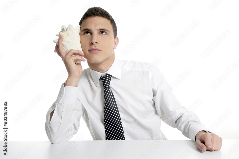 Businessman with sea shell isolated on white studio background Businessman with sea shell isolated on white studio background