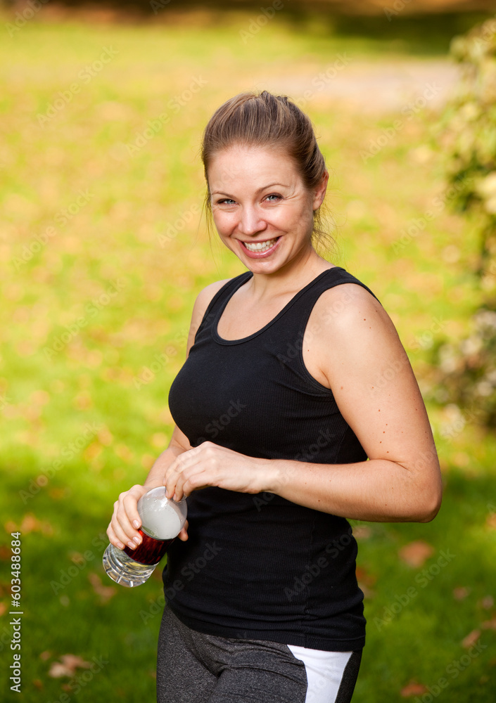 A woman taking a break from exercising in the park A woman taking a break from exercising in the park