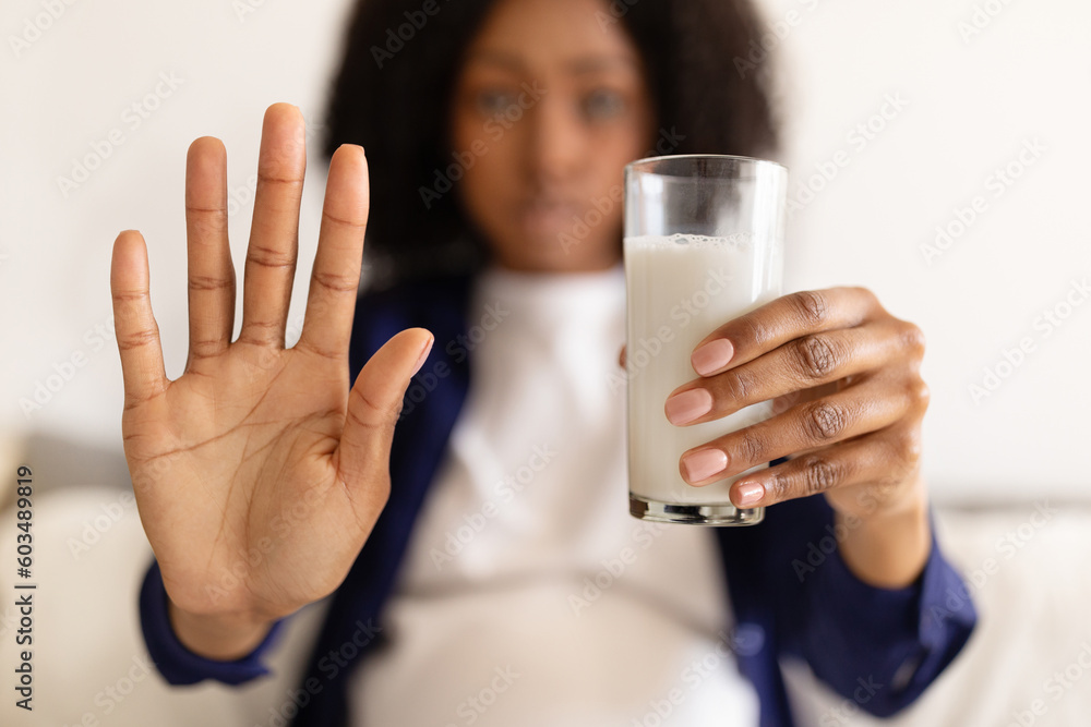 Sad serious confident curly pregnant millennial black woman in domestic clothes with big belly make stop sign Sad serious confident curly pregnant millennial black woman in domestic clothes with big belly make stop sign