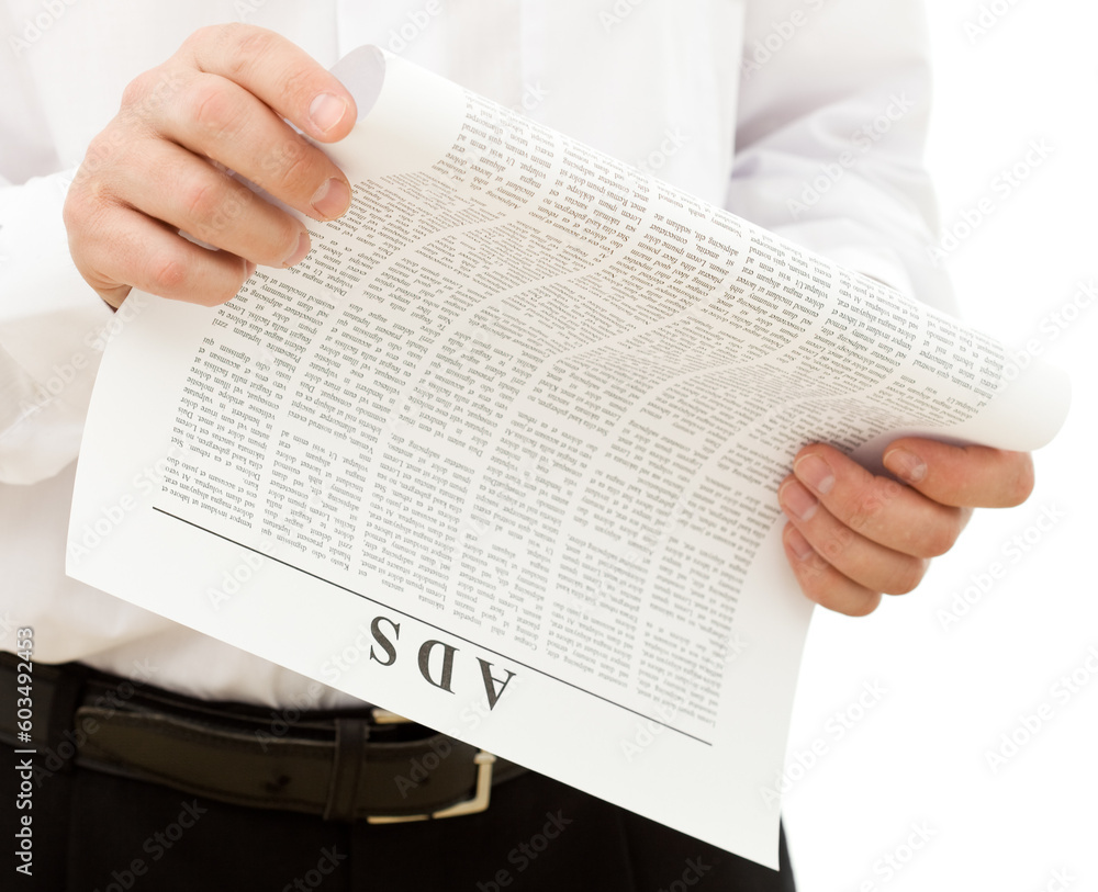 Naklejka premium Man reading ads from the paper - isolated, closeup
