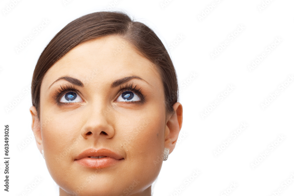 Closeup of a thoughtful young woman looking up over white background Closeup of a thoughtful young woman looking up over white background