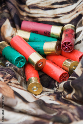 Still life shot of shotgun shells against camouflage clothing.