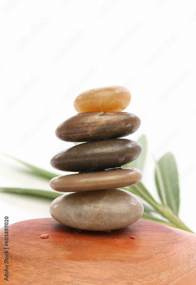 Balancing stones with leaves and white background Balancing stones with leaves and white background