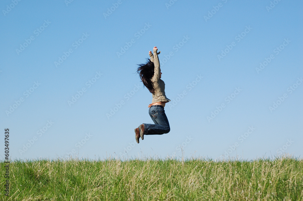 happy woman jumping on green meadow happy woman jumping on green meadow