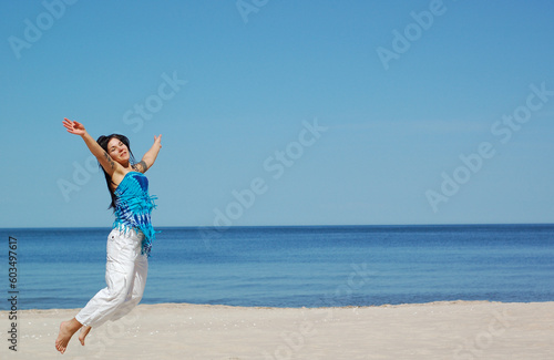 attractive woman jumping on the beach