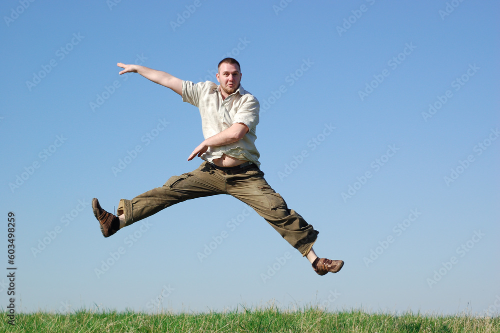 happy man jumping on green meadow happy man jumping on green meadow