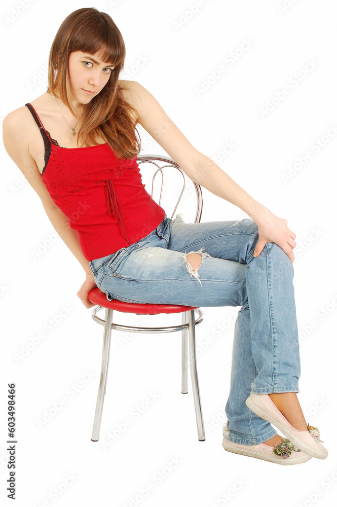 Beutiful young girl sitting on a chair. isolated on white Beutiful young girl sitting on a chair. isolated on white