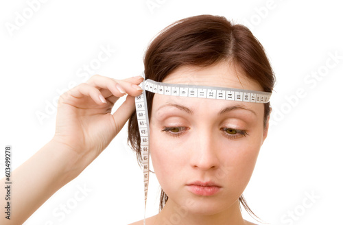 Young woman - measuring brain size (isolated on white) photo