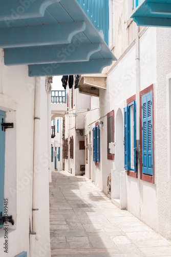 street in the old town of mandraki nisyros island greece country kos santorini travel sightseeing wandering vertical wallpaper white houses with blue shutters © ms16_photo