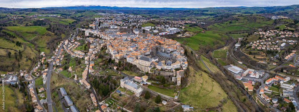 Aerial above the old town of Saint-Flour in France on a sunny day in early spring.