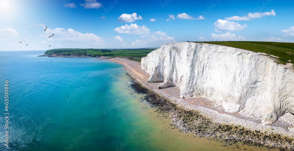 Panoramic aerial drone view of the famous Seven Sisters Chalk cliffs, Sussex, England, in early summer with sunshine and calm sea