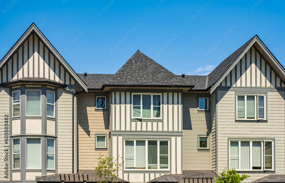 Facade of new residential townhouses. Apartment buildings in Canada. Modern complex of apartment buildings in summer