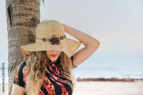 young girl with hat on the beach