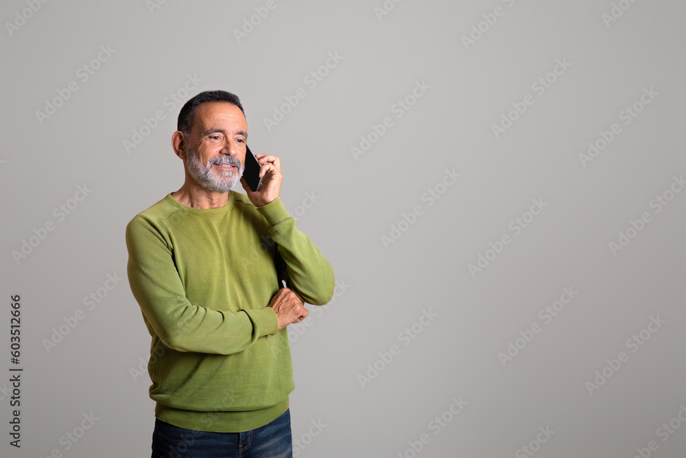 Smiling handsome old european man calls by smartphone, talking Smiling handsome old european man calls by smartphone, talking