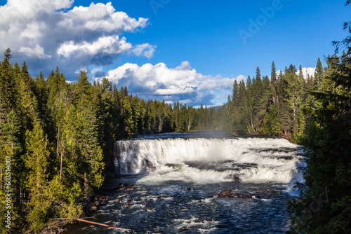 Wide-fronted waterfall, large, frothing cascade into the Murtle River amid spruce forests. Helmcken Falls is a 141 m (463 ft) waterfall on the Murtle River within Wells Gray Provincial Park in British