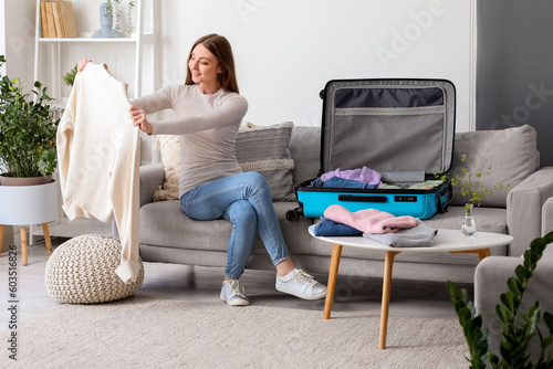 Young woman unpacking her c...