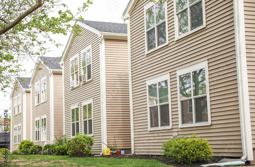 American house suburbs front entrance townhomes symbolize desirable living, investment, and the real estate market. They represent the allure of homeownership and the dynamics of buying and selling pr