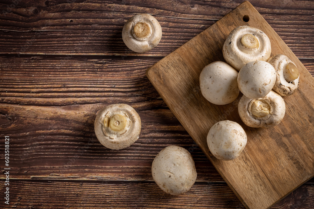 Fresh white mushrooms on the table.