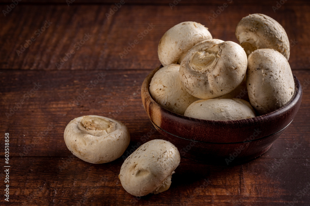 Fresh white mushrooms on the table.