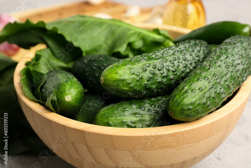 Bowl with fresh cucumbers for preservation on table, closeup