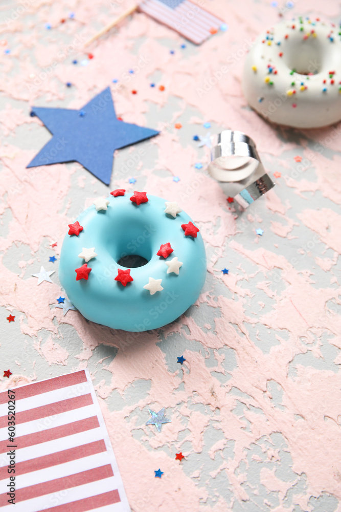 Composition with donuts, stars and confetti on pink grunge table. Independence Day celebration Composition with donuts, stars and confetti on pink grunge table. Independence Day celebration