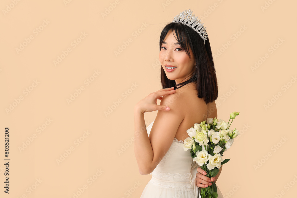 Beautiful young Asian bride with bouquet of eustoma flowers on beige background Beautiful young Asian bride with bouquet of eustoma flowers on beige background