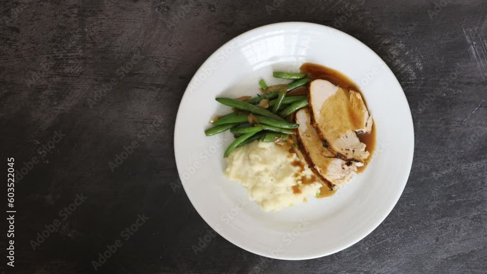 Serving a Plate of Turkey with Mashed Potatoes and Green Beans Serving a Plate of Turkey with Mashed Potatoes and Green Beans