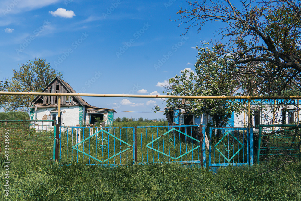 Countryside. The fence of a house destroyed by artillery shelling. War in Ukraine Countryside. The fence of a house destroyed by artillery shelling. War in Ukraine