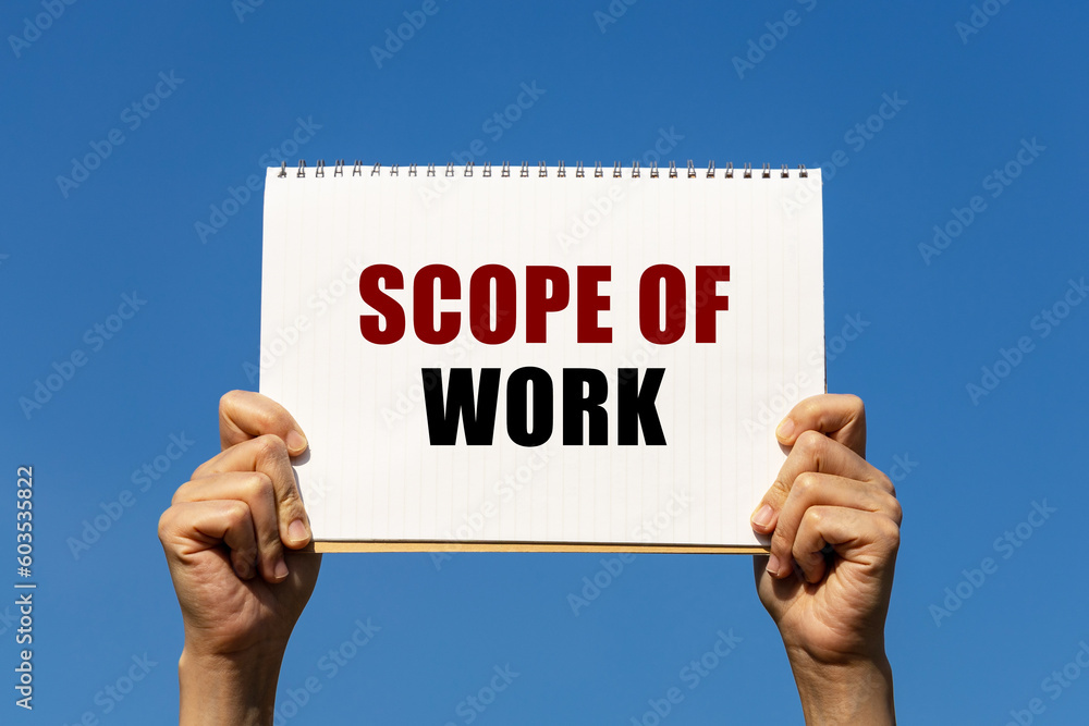 Scope of work text on notebook paper held by 2 hands with isolated blue sky background. This message can be used as business concept about scope of work. Scope of work text on notebook paper held by 2 hands with isolated blue sky background. This message can be used as business concept about scope of work.