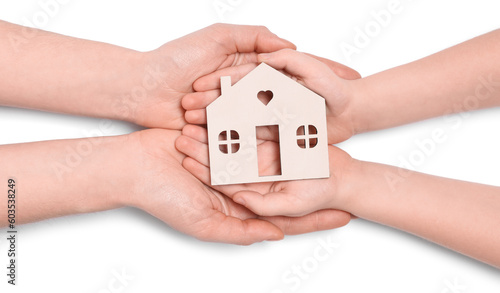 Home security concept. Woman with her little child holding house model on white background, top view