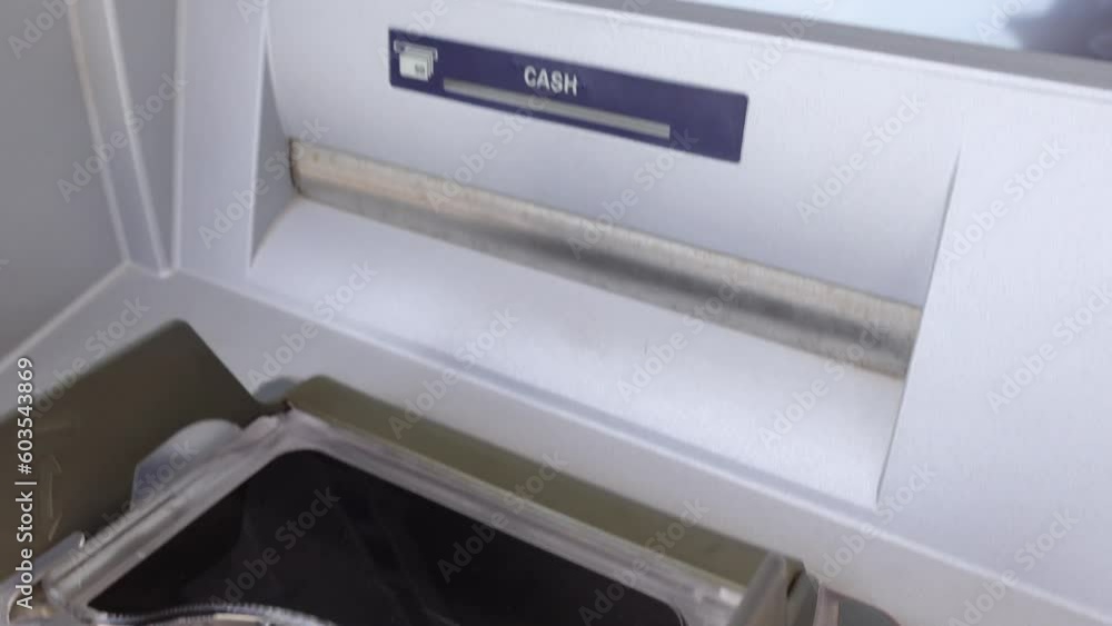 ATM gives out bunch of money cash taken from bank credit card by tourist. Person takes money from ATM for making purchases in shops ATM gives out bunch of money cash taken from bank credit card by tourist. Person takes money from ATM for making purchases in shops
