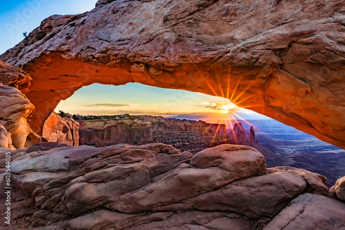 A representative arch of the place. The rays of the sun just before sunset piercing the arched space of the carved stone. Canyonlands National Park is an American national park located in southeastern