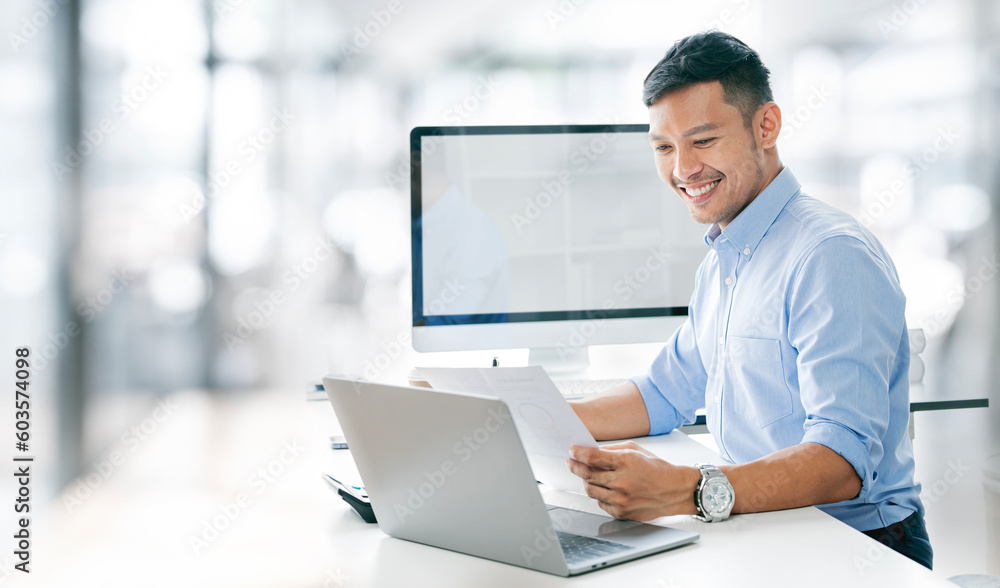 Young business man working at home office with laptop and papers on desk Young business man working at home office with laptop and papers on desk