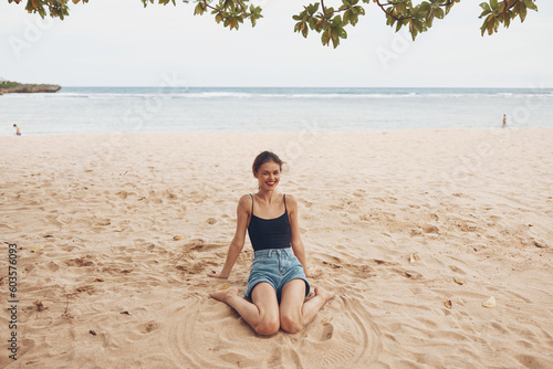 woman travel lifestyle sitting beach vacation smile sea freedom sand nature