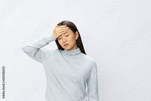 Asian woman holding her hand to her head for severe headache, migraine white background © SHOTPRIME STUDIO