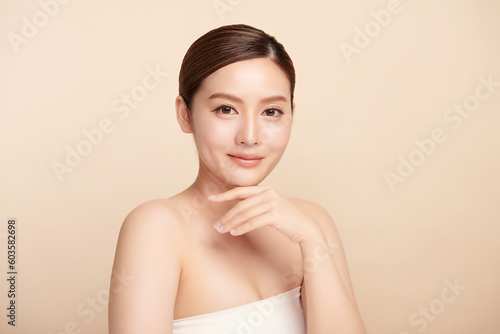 Beautiful young asian woman with clean fresh skin on beige background, Face care, Facial treatment, Cosmetology, beauty and spa, Asian women portrait.