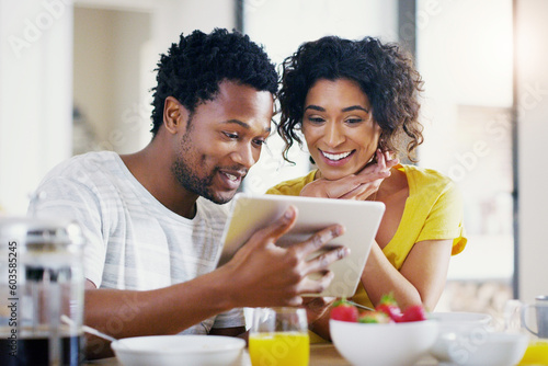 Online, morning and breakfast with couple and tablet for social media, news and app. Happy, love and smile with man and woman browsing together at home for internet, technology and communication