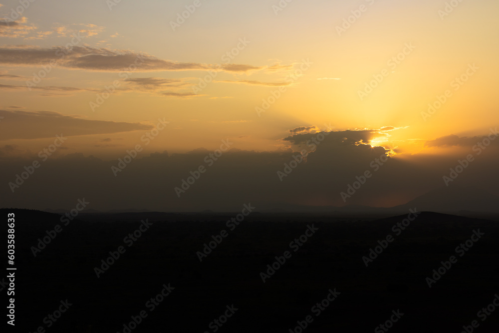 African landscape with mountains silhouettes and sunset, Amboseli National Park, Kenya.