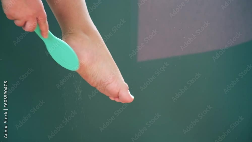 A metallic foot file for pedicure. One side is rough. It is designed to
