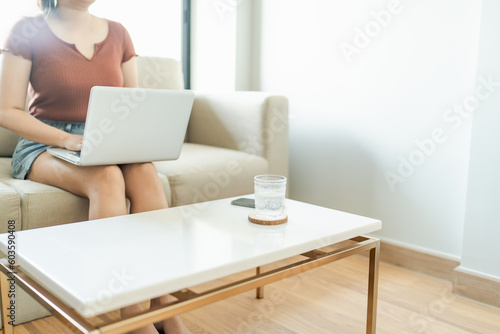 woman using computer laptop for work online at living room.