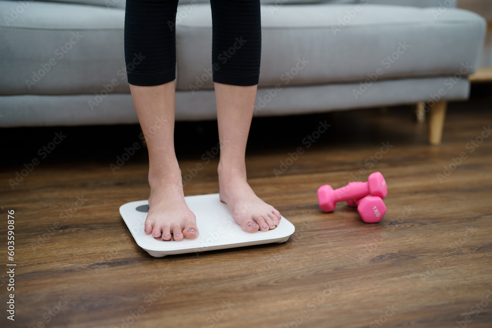 Fat diet and scale feet standing on electronic scales for weight control. Measurement instrument in kilogram for a diet control Fat diet and scale feet standing on electronic scales for weight control. Measurement instrument in kilogram for a diet control