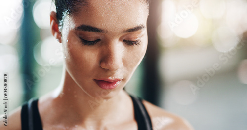 Fitness, workout and female athlete sweating in the gym after sports and strength training. Motivation, goals and woman doing a wellness and health exercise with focus in a sport center or studio.