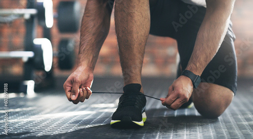 Closeup, exercise and man tie shoes, fitness and start workout with training, wellness and healthy lifestyle. Zoom, male person or athlete with laces, sneakers and prepare for practice or performance