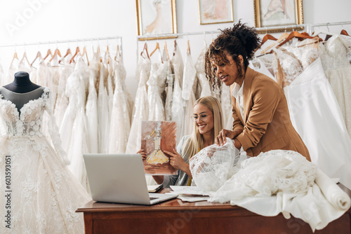 Workers in a bridal salon talk to a costumer over video call.
