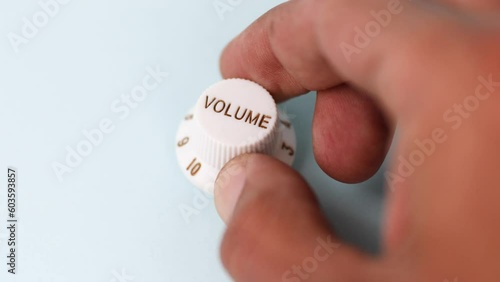 Close up of a black male hand turning volume level