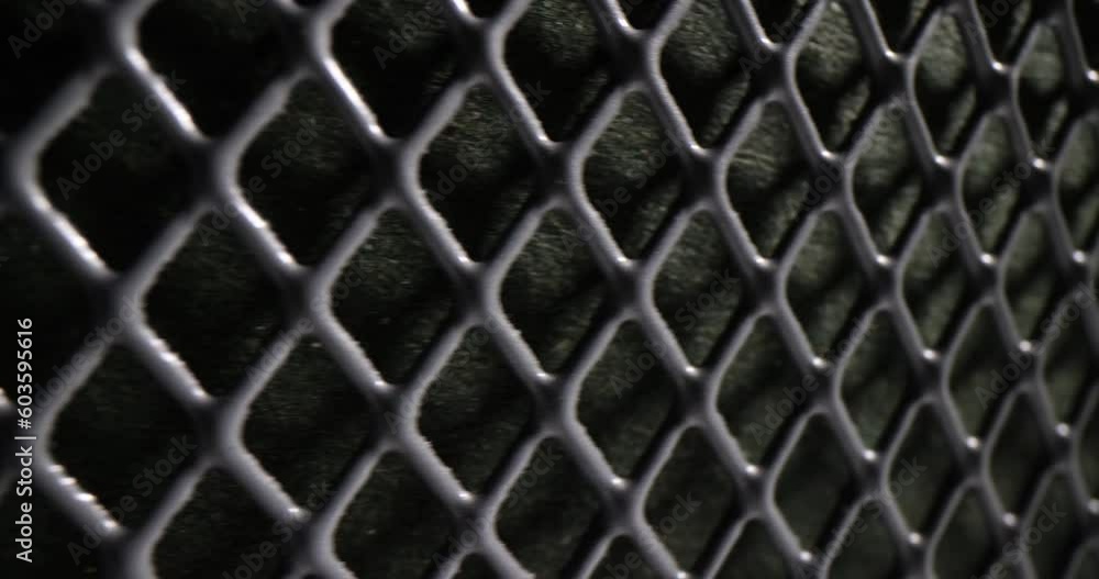 Durable protective metal mesh with small square cells quickly changes. Dark metal grid pattern and texture as seamless design element Durable protective metal mesh with small square cells quickly changes. Dark metal grid pattern and texture as seamless design element