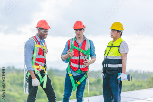 Technician engineer service meeting and checking solar cell on rooftop of industrial factory. Inspection worker repair solar cell panels. Clean Renewable energy, Ecology and alternative power concept