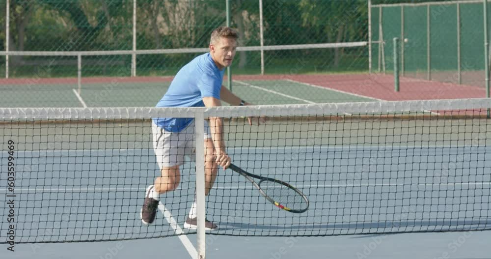 Caucasian male tennis player celebrating point against diverse opponent on court in slow motion Caucasian male tennis player celebrating point against diverse opponent on court in slow motion