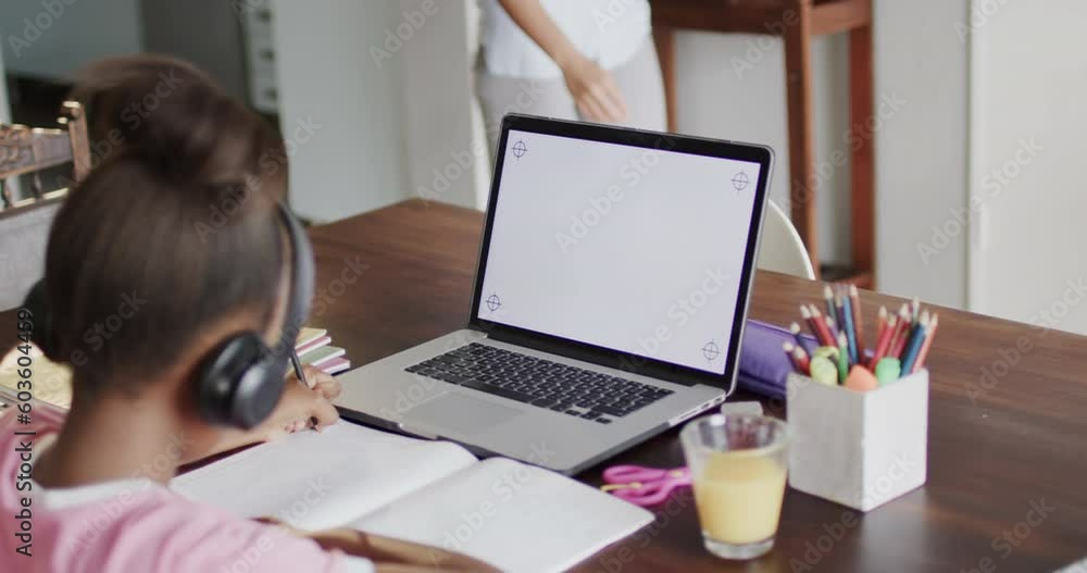 African american girl using laptop with copy space on screen, slow motion African american girl using laptop with copy space on screen, slow motion